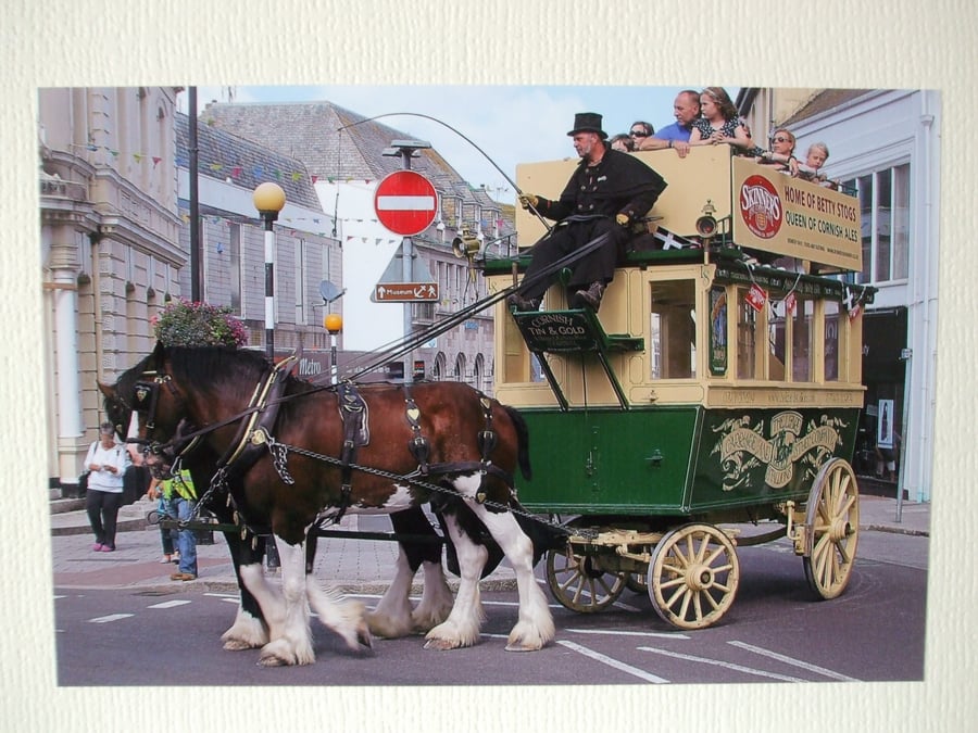 Photographic greetings card of two horses pulling an open top bus.