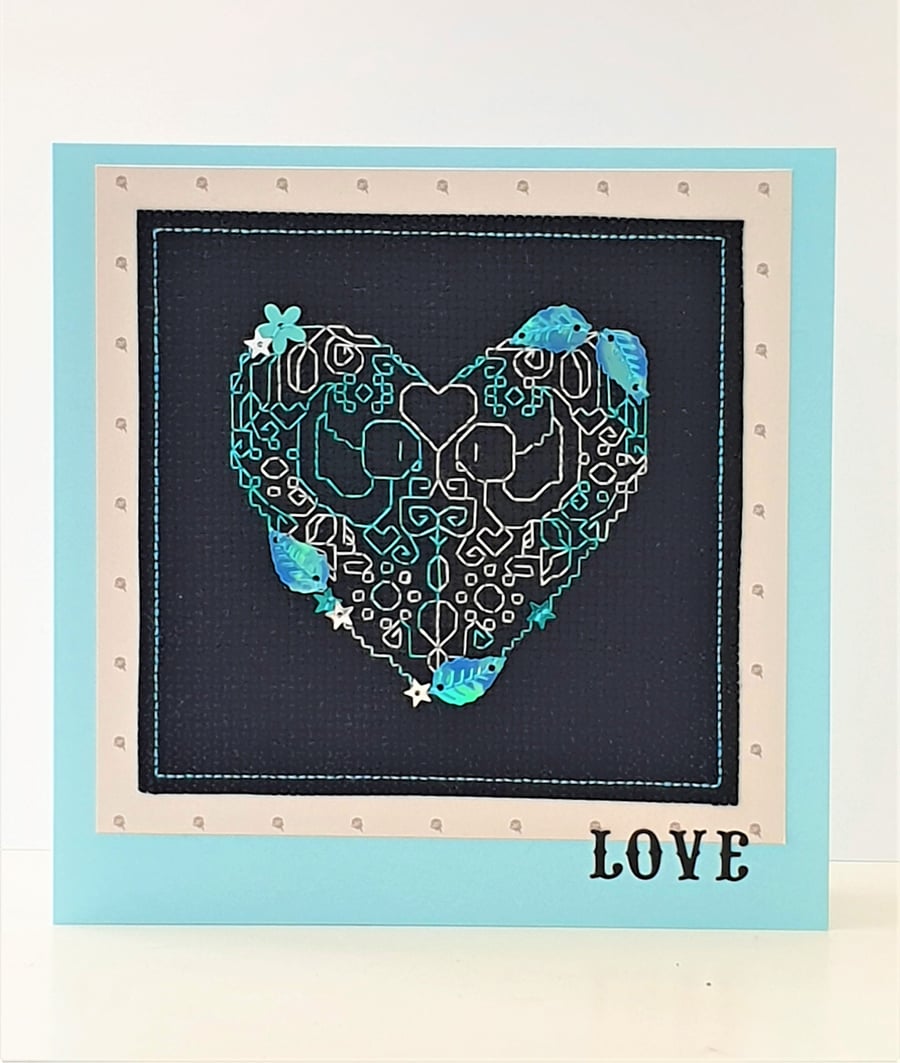 Heart cross stitch card with sequin embellishments and the wording 'Love'