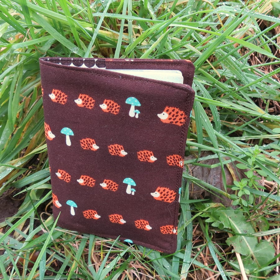 Hedgehogs.  A passport sleeve with a hedgehogs design.  Passport cover.