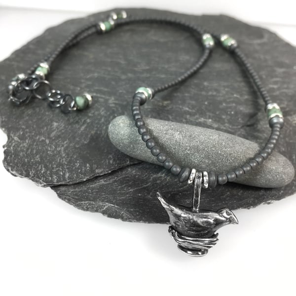 Sterling silver bird on nest necklace with hematite and African turquoise beads 
