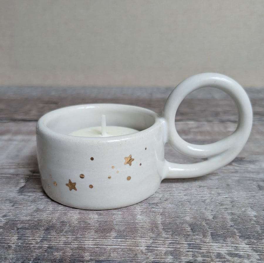 White ceramic tealight holder with gold stars