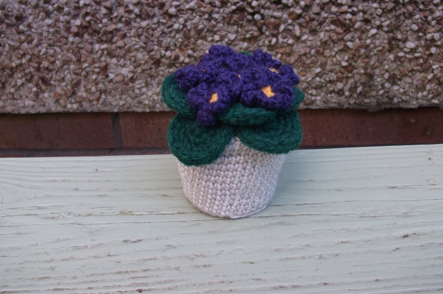 Crochet violets  in a crochet pot.