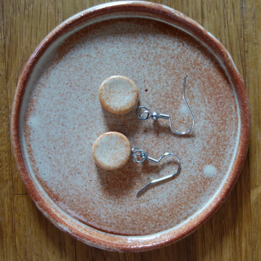 Ceramic disc dangle earrings in orange cream 
