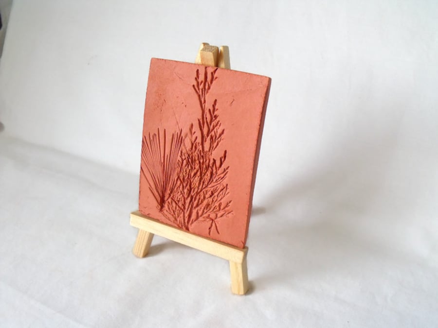 terracotta impressed clay tile displayed on an easel, number 2 of 8 available