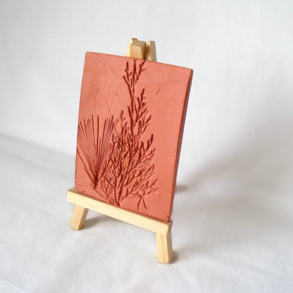 terracotta impressed clay tile displayed on an easel, number 2 of 8 available