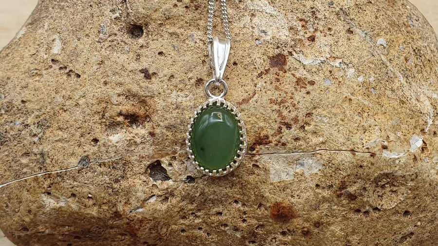 Tiny Nephrite Jade pendant. 925 sterling silver crown edge