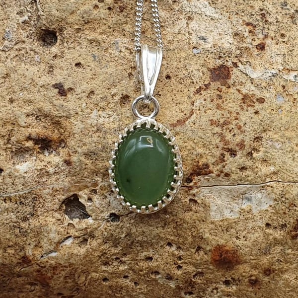 Tiny Nephrite Jade pendant. 925 sterling silver crown edge