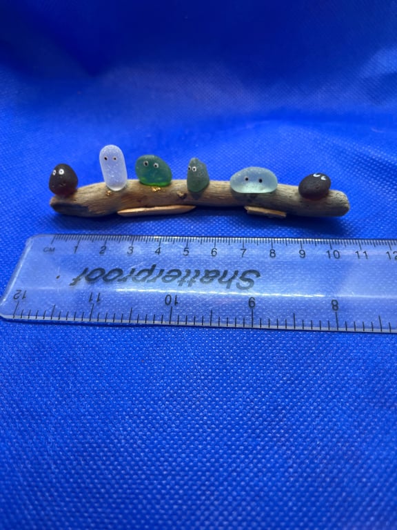 Sea glass nuggets on driftwood.