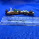 Sea glass 'nuggets' on driftwood.