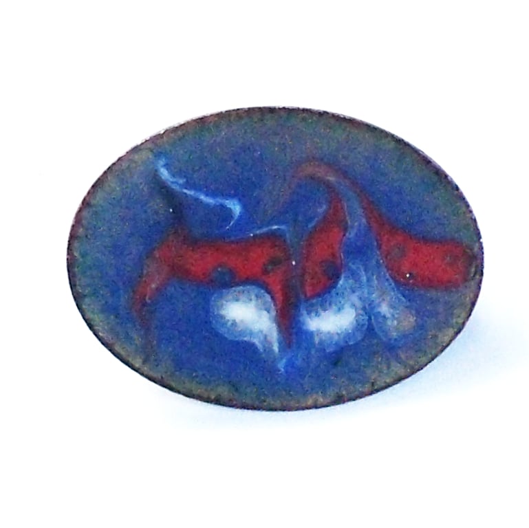 large oval brooch scrolled white and red on blue over clear enamel