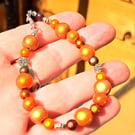 Bracelet with disco beads, brown, orange and silver spacers