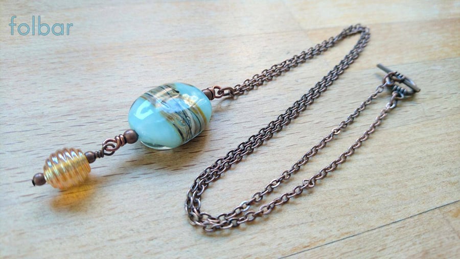 Blue and gold lamp work bead pendant on copper chain