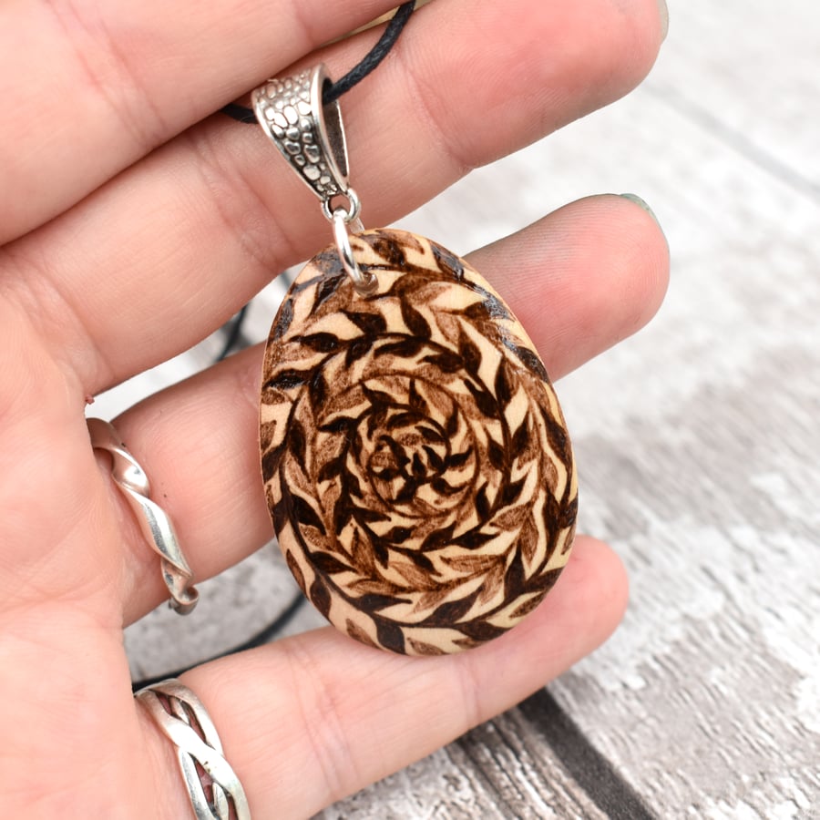 Twisted spiral tendrils. Pyrography nature inspired wooden pendant.
