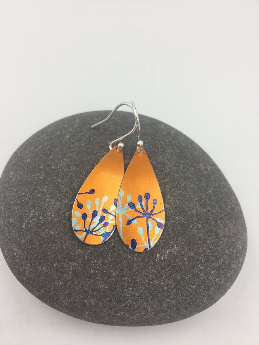 Orange anodised aluminium cow parsley drop earrings.