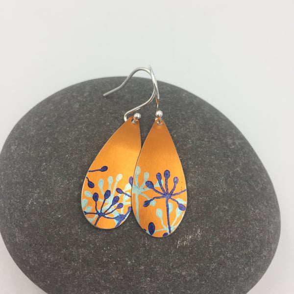 Orange anodised aluminium cow parsley drop earrings.