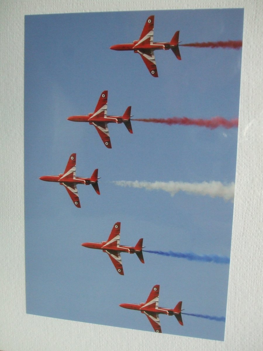 Photographic greetings card of the Red Arrows,  trailing red, white & blue smoke