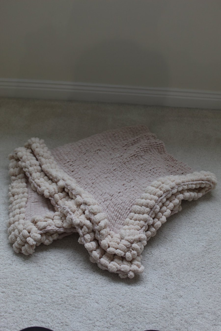 Very Soft Cream Baby Blanket with pom pom edging.