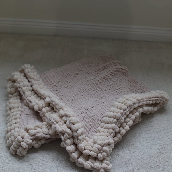 Very Soft Cream Baby Blanket with pom pom edging.