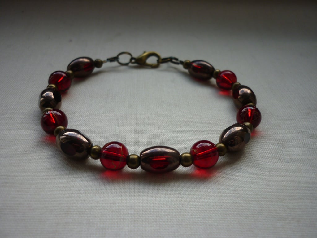 BRONZE & RED BRACELET.  1099