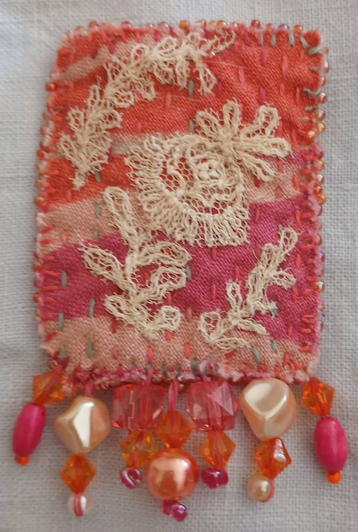 Orange and hot-pink textile art brooch 