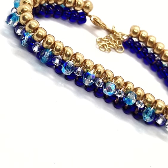 Gold, royal blue and shimmering blue tennis-style beaded bracelet