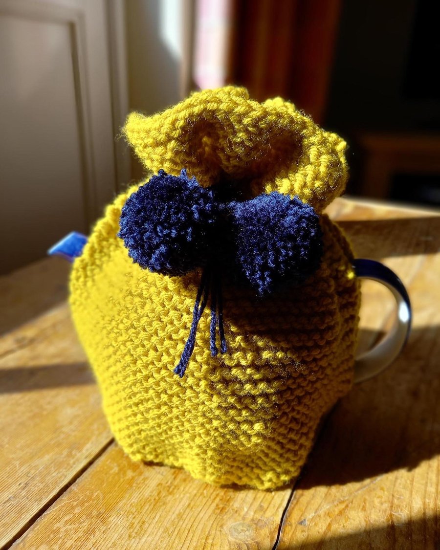 Hand knitted 2 pint (4 cup) tea cosy in Mustard yellow with Navy Pom poms