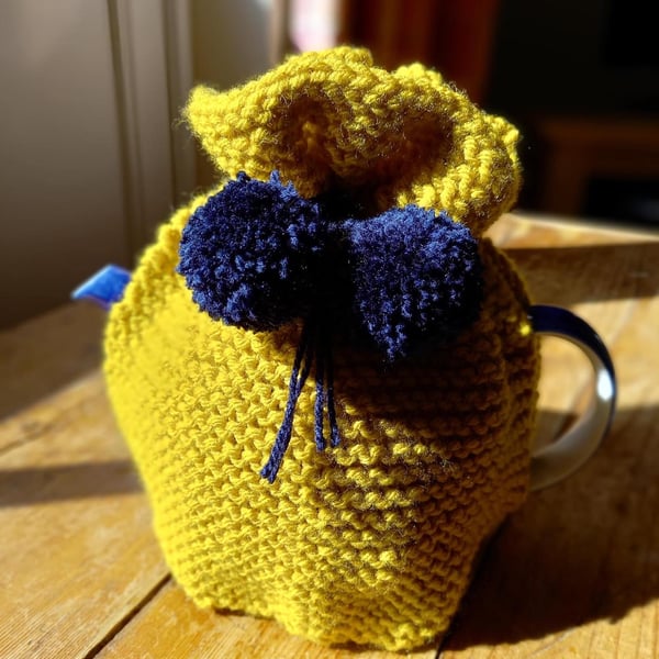 Hand knitted 2 pint (4 cup) tea cosy in Mustard yellow with Navy Pom poms