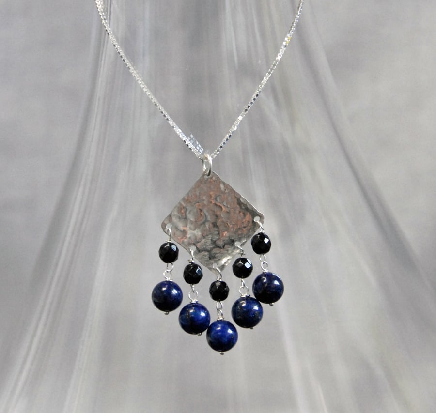 Fringed hammered silver and blue lapis pendant