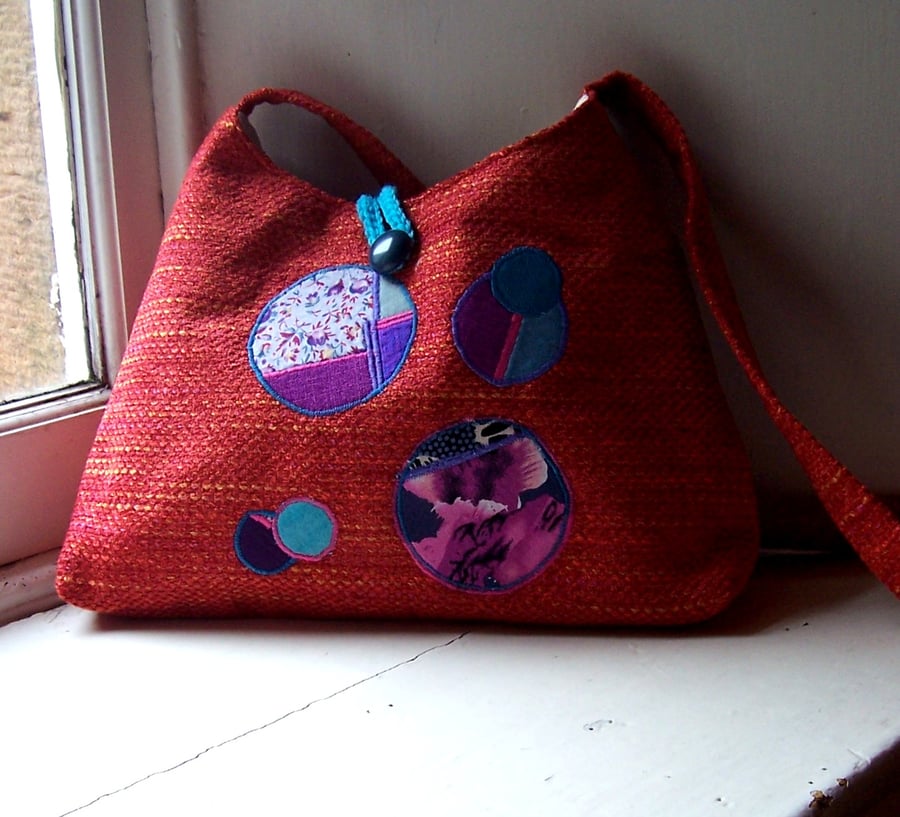 Fabric shoulder bag with feature appliques