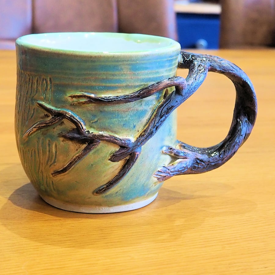 Pottery tree mug finished in green and brown bark colour glazes