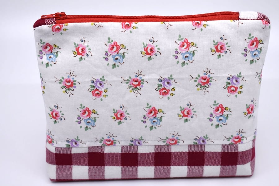 Pretty cotton print & red gingham topped with a red zip make this pouch special.