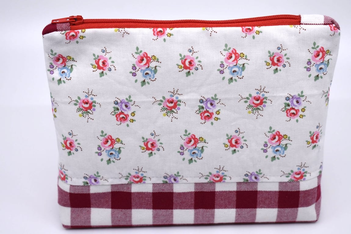 Pretty cotton print & red gingham topped with a red zip make this pouch special.