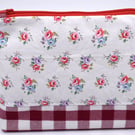 Pretty cotton print & red gingham topped with a red zip make this pouch special.