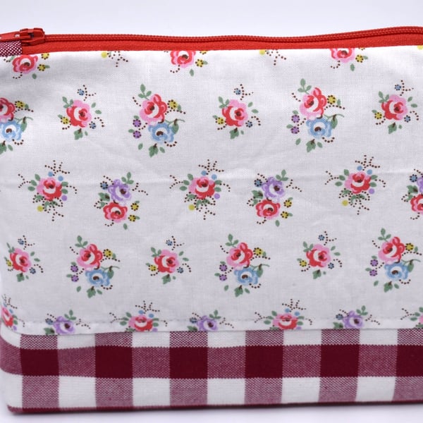 Pretty cotton print & red gingham topped with a red zip make this pouch special.