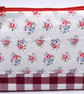 Pretty cotton print & red gingham topped with a red zip make this pouch special.