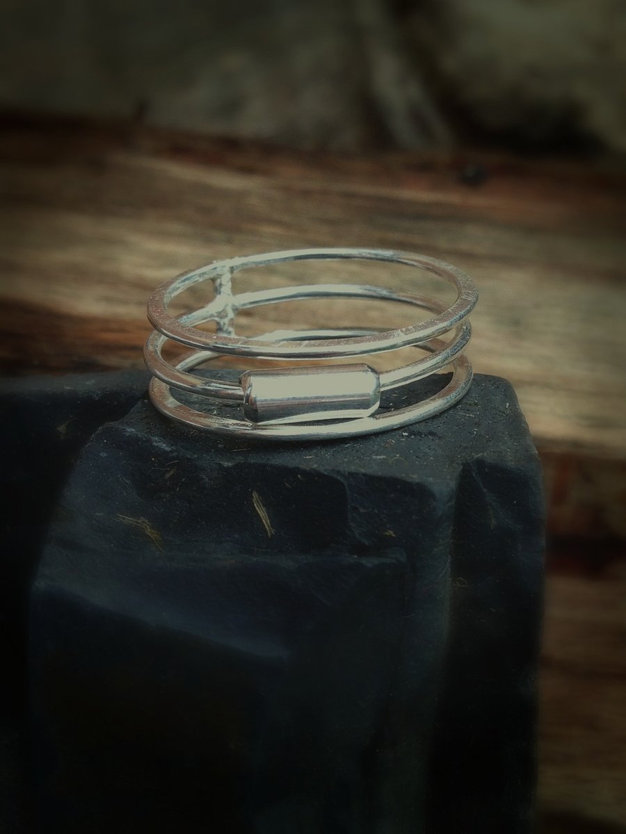 A sterling silver multi layered ring with a moveable silver tube. Mothers day