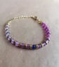 Charter bracelet, pink mix, blue centre. 
