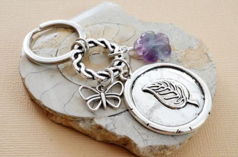 Carved purple fluorite flower, wax seal leaf and butterfly keyring.