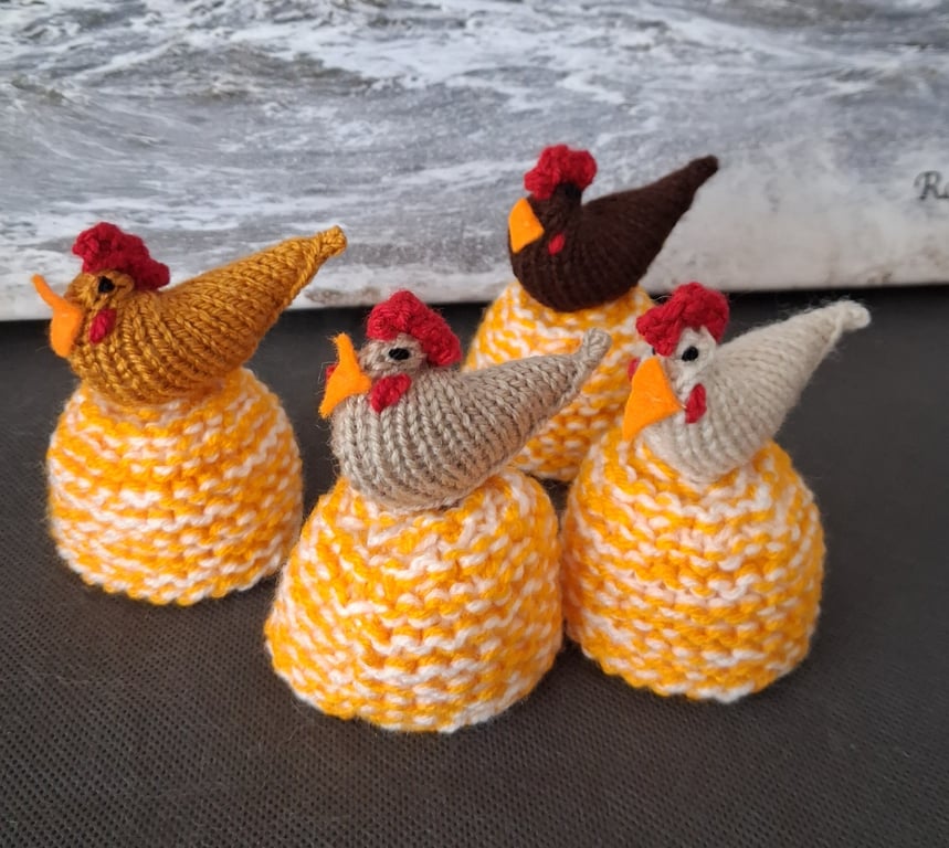 A Set Of Four Egg Cosies With A chicken On Top Of Each (R301)