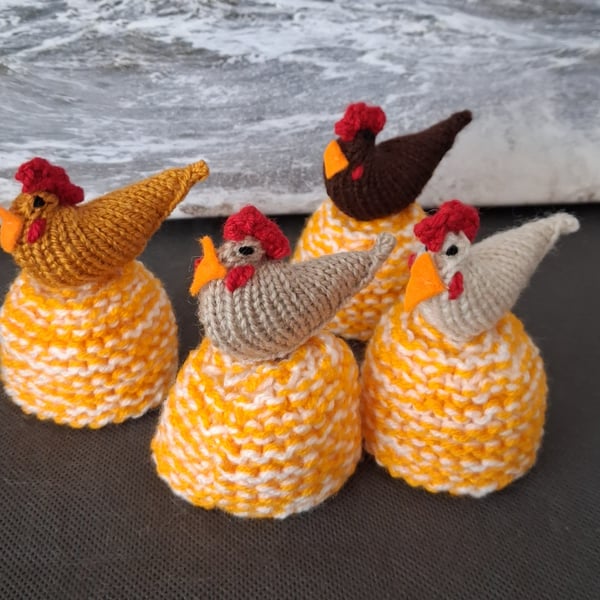 A Set Of Four Egg Cosies With A chicken On Top Of Each (R301)