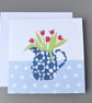 Jug of red tulips in a blue and white patterned jug on spotty tablecloth card - Image 1