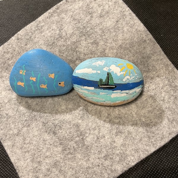 Set of 2 hand painted pebbles with sailing and seaside theme.