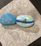 Set of 2 hand painted pebbles with sailing and seaside theme.