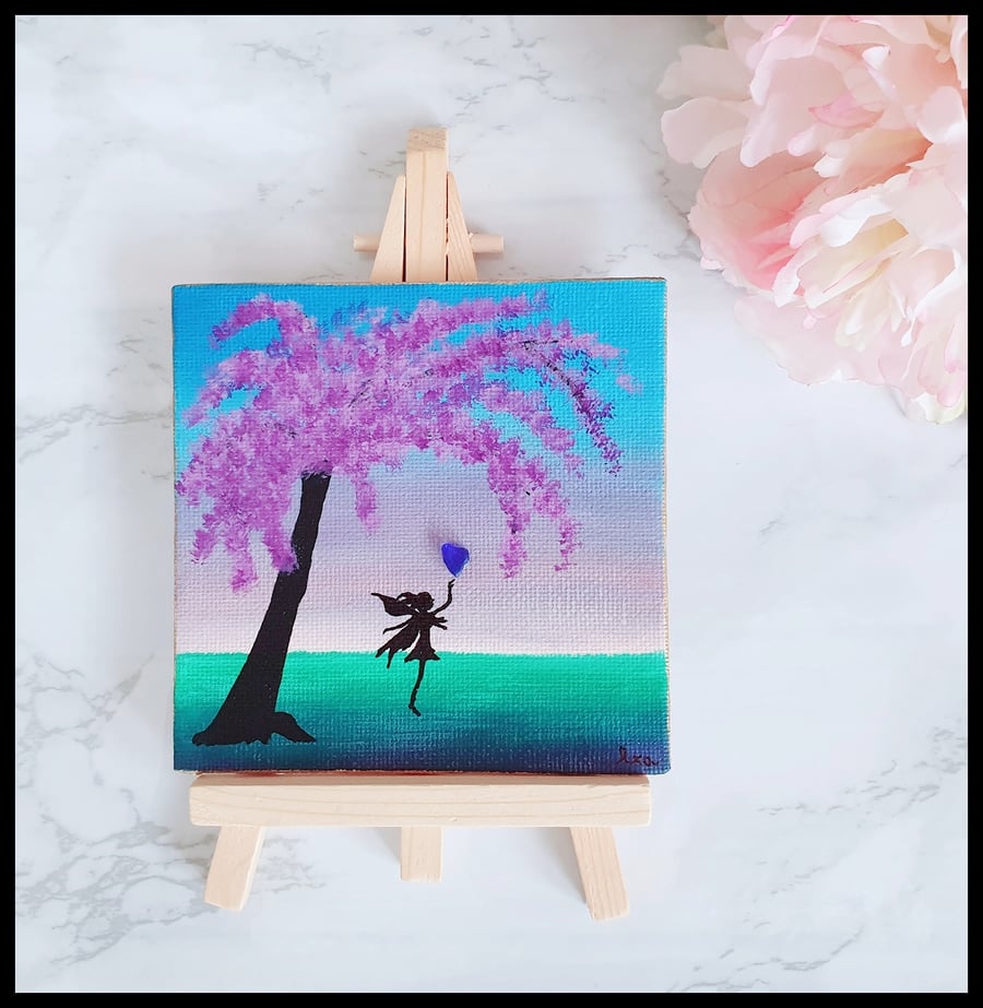 Whimsical fairy with wisteria tree and blue heart seaglass