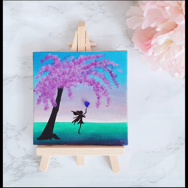 Whimsical fairy with wisteria tree and blue heart seaglass