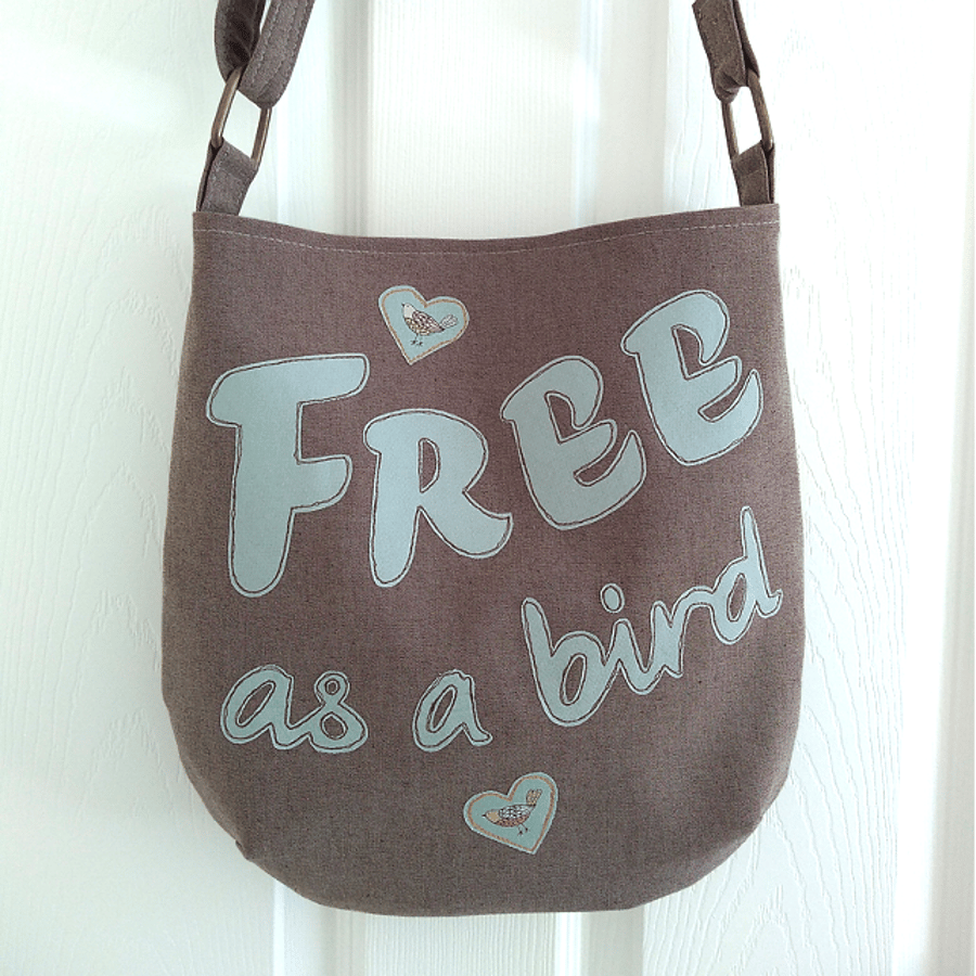 Brown ‘FREE as a bird’ crossbody bag with mint green lettering