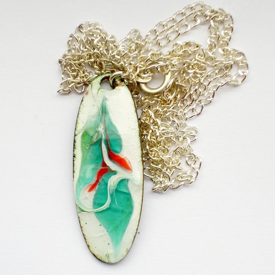 turquoise and red on white, scrolled oval pendant 