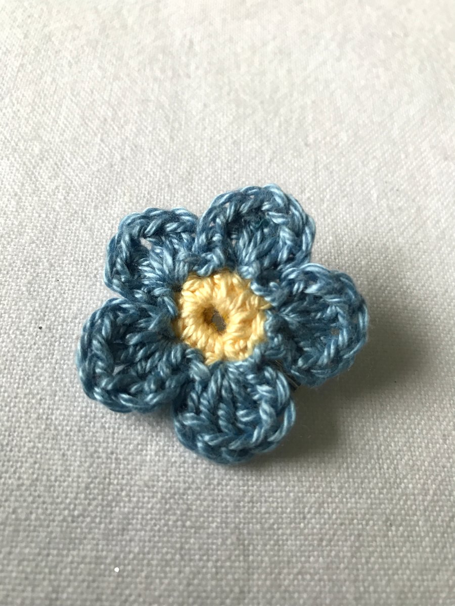 Crocheted forget-me-not brooch