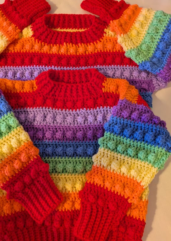 Rainbow coloured jumper for four to five year old children 