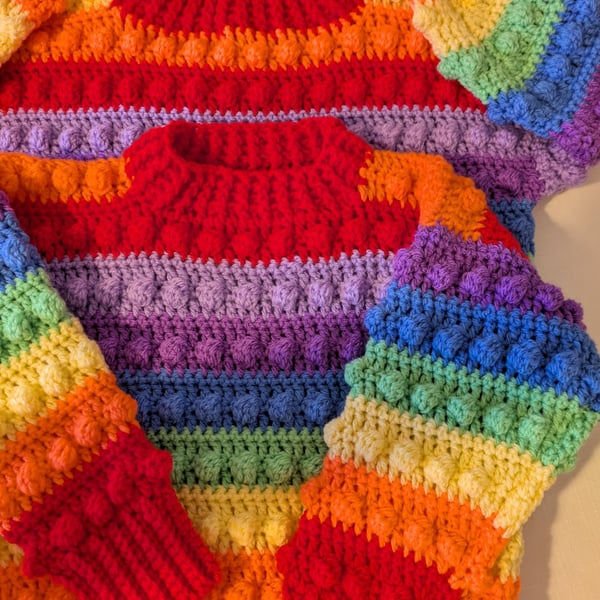 Rainbow coloured jumper for four to five year old children 